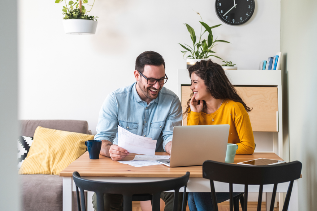 A couple at home on their laptop working through paperwork